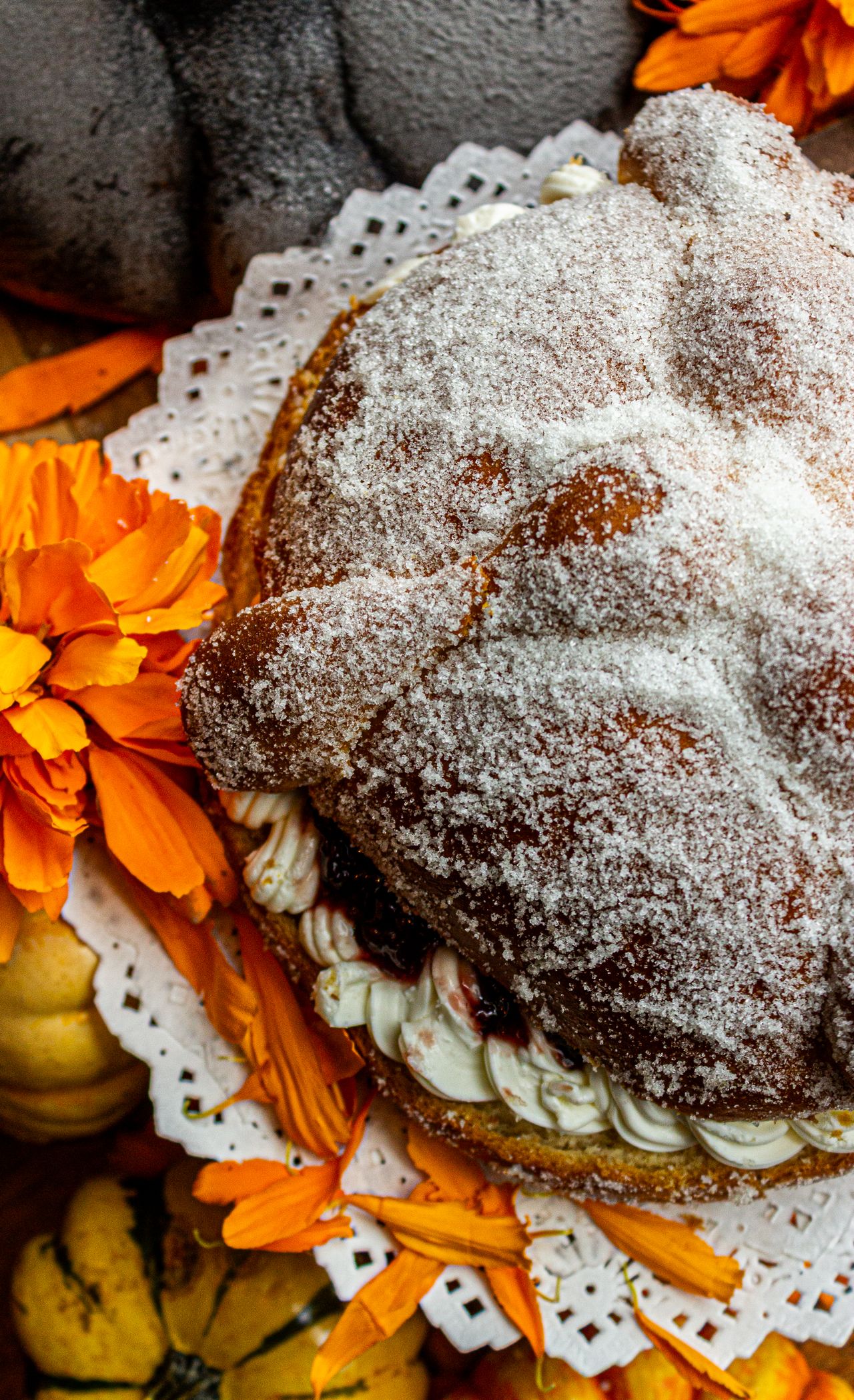 Bánh pan de muerto bày cùng hoa cúc vạn thọ
